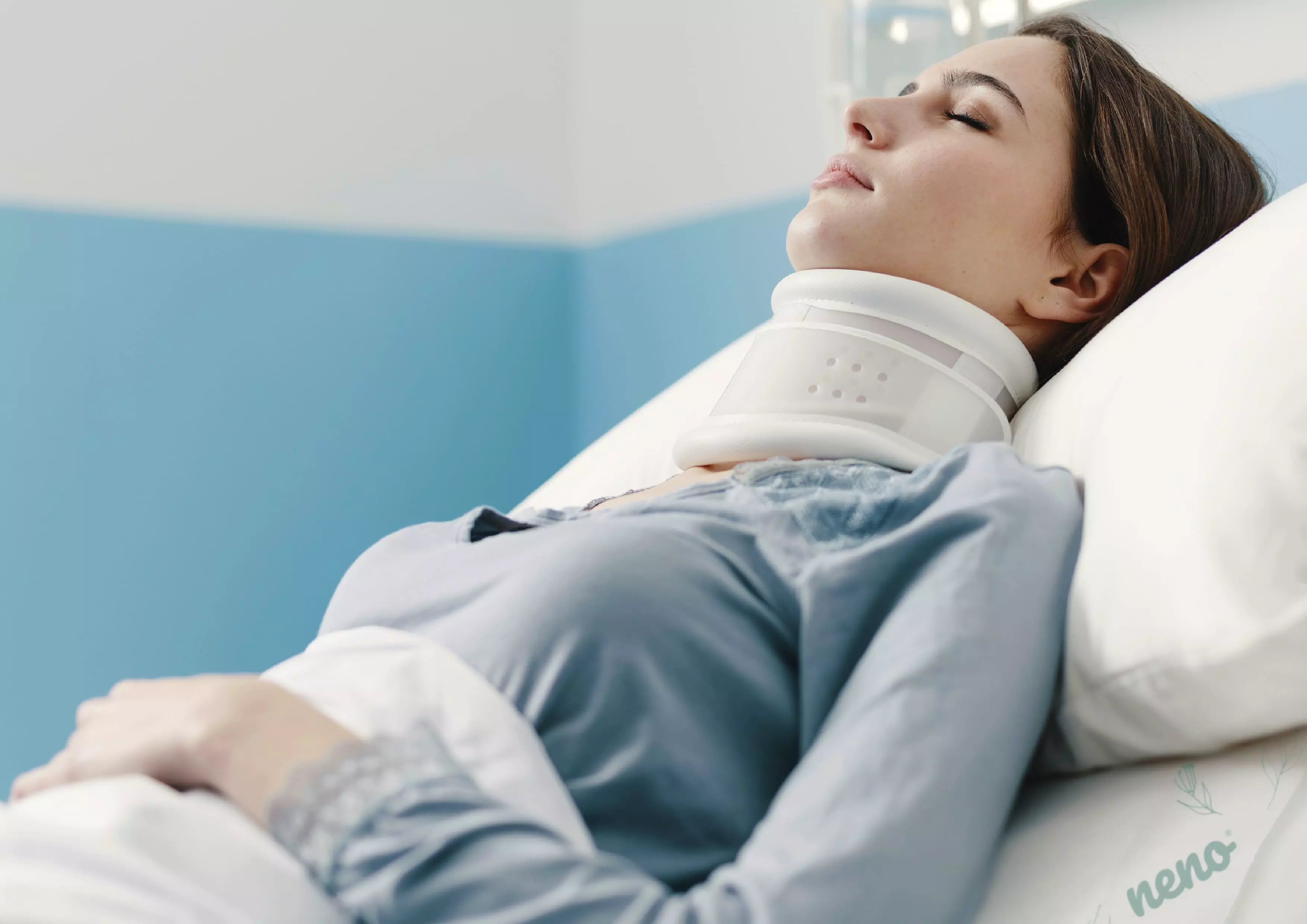 woman in hospital with stiffening collar
